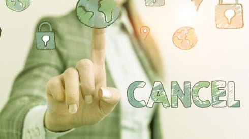 Businesswoman pointing to images of globes and location markers with the word cancel written on the right