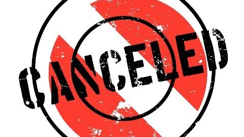 A red circle with a white line through it and the word canceled over it in black