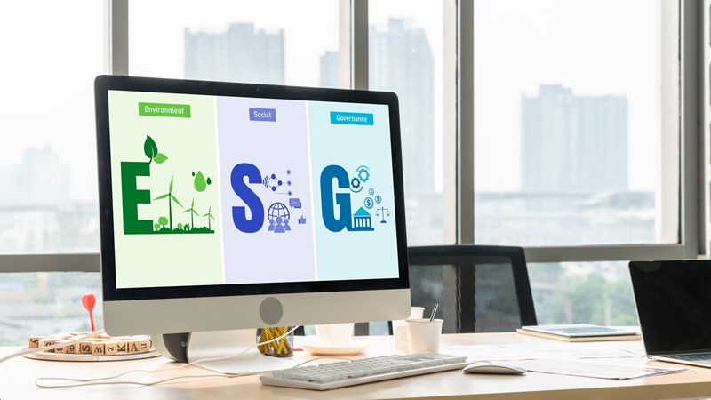 Computer Monitor on an Office Desk with Environment Social Governance and Acronym Displayed on Scnree - Skyline in Background