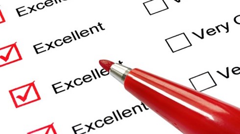 A list of ratings with all of the "excellent" boxes checked in red pen with the red pen visible in the picture