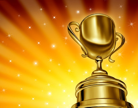 Gold award trophy with stars in background