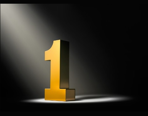 In a dark area a golden number One is spotlighted