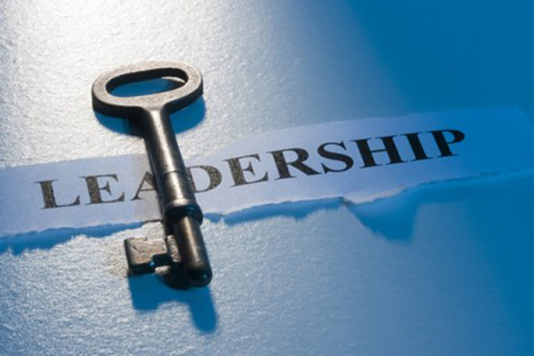 A skeleton key lying on top of the word LEADERSHIP