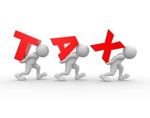 Men carrying the words spelling TAX on their backs