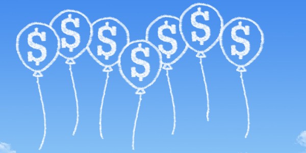 Clouds in the sky in the shape of baloons embossed with dollar signs
