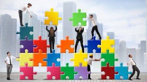 People moving colorful vertifcal puzzle pieces with buildings in the background