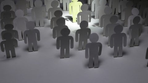 People figures In gray with one standing out in light green