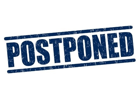 The Word Postponed Rubber Stamped in Blue