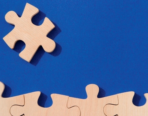 Wooden puzzle pieces on a blue background