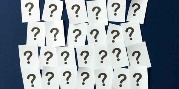 Four rows of sheets of paper with a question mark printed on each