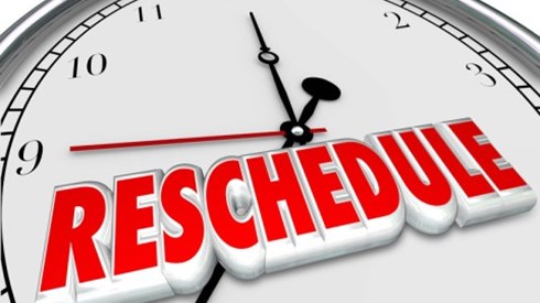 The top half of a clock with the word reschedule written on it