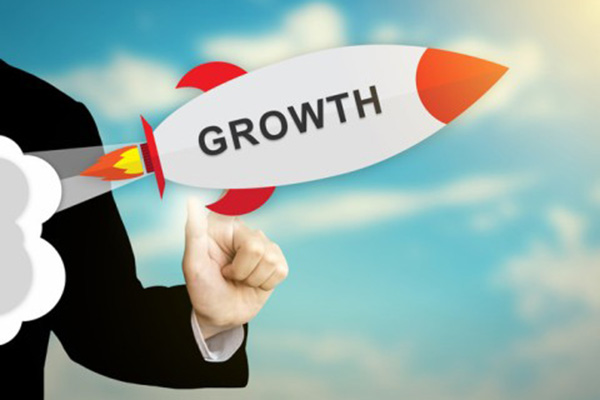 An animated rocket with the word GROWTH on it is launched by a business professional and directed upwards toward the sun