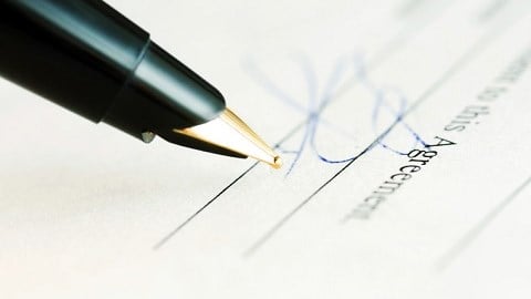 Pen next to a signature on a legal document