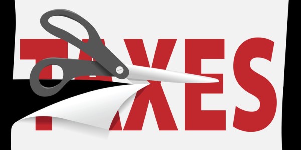 Scissors cutting through the word Taxes