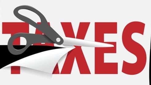 Scissors cutting through the word Taxes