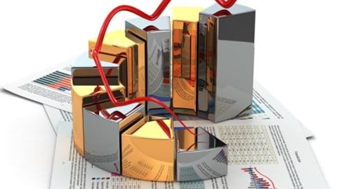 An arrow is bouncing from the tops of a 3D growing circular bar graph which is sitting on top of financial reports