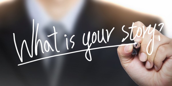 Businessperson writing "What is Your Story?" 