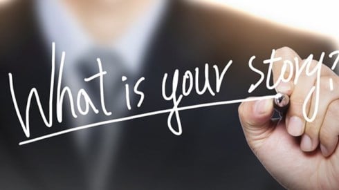 Businessperson writing "What is Your Story?"