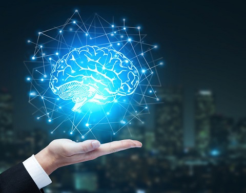 In a businessman´s palm is a hologram of a brain emitting connected lines and points in front of a city´s nighttime skyline