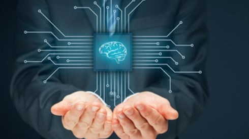 Businessman holding an enlarged microchip with a human brain