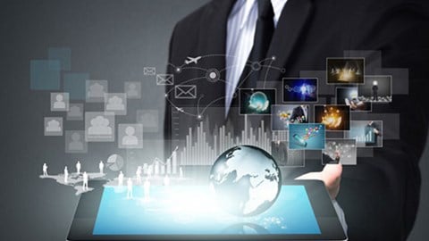A businessman holding a tablet emitting a hologram of a blue Earth