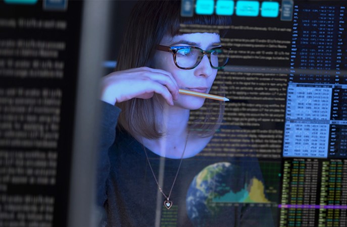 Woman reading and researching information on a screen