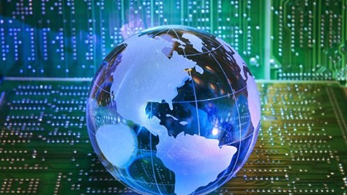 A blue glass globe sitting on a green circuit board with a green circuit board in the background