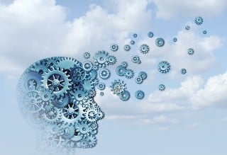 Learning Cloud-SF2 Male head profile filled with different sized gears with some of the gears leaving the forehead and floating into the sky