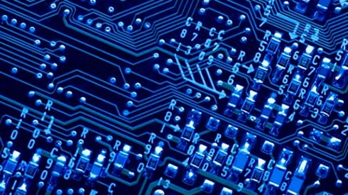 Technological drawing of a circuit board with light blue letters and numbers and connections against dark blue