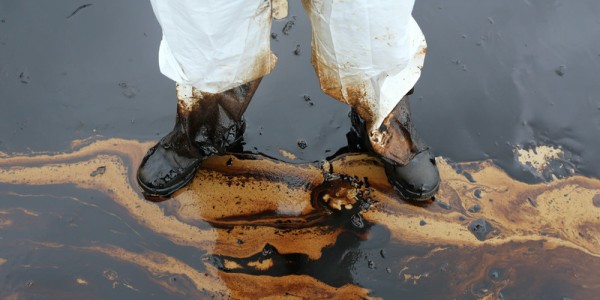 Man Standing in Crude Oil Spill