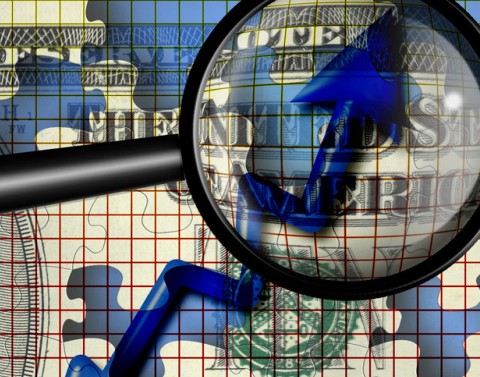 A magnifying glass looking at an increasing blue arrow with a dollar puzzle piece background