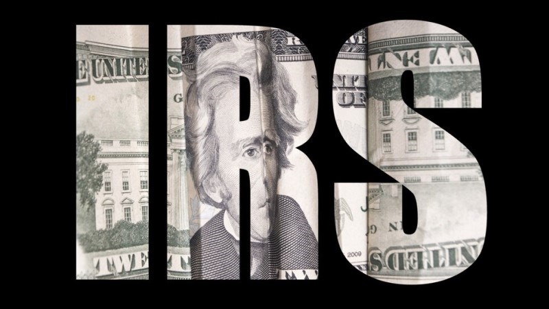 IRS Lettered with $20 bill on black background