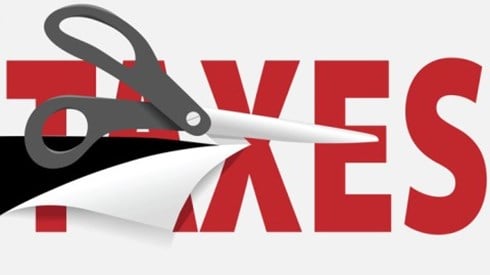 Scissors cutting through the word taxes