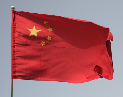 The Chinese flag is red and in upper left corner has four small stars in a semicircle around one large star