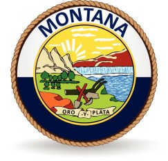A rope circles the word MONTANA and the state seal which is a sunrise shining over landscape and farming and mining tools