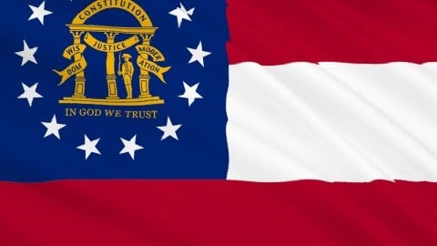 The flag of Georgia has stripes of red-white-red and at upper left a blue square with the coat of arms surrounded by 13 stars