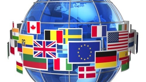 Blue globe with wire cage around it and flags of countries hovering around the middle of the globe