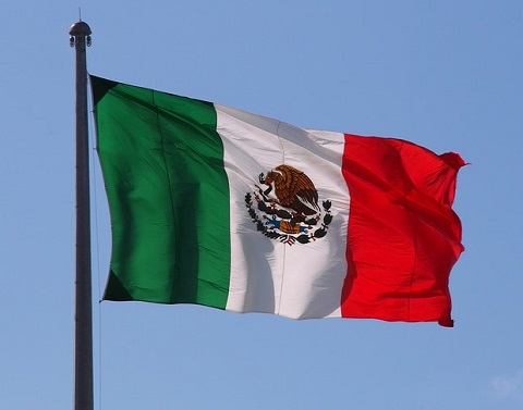 Flag of Mexico waving against a blue sky