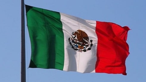 Flag of Mexico waving against a blue sky
