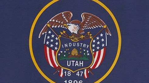 Utah flag--navy blue background, gold circle with eagle, flag, Industry, Utah, 1847, 1896 inside