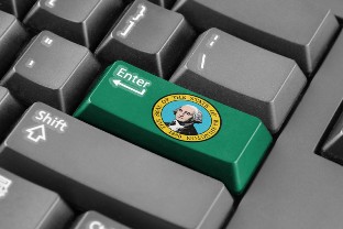 The Enter key on a computer keyboard is green and has the Washington State seal