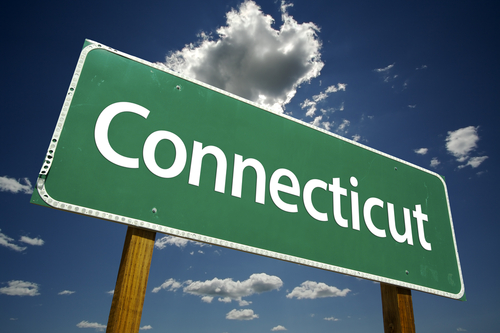 Connecticut road sign under blue cloudy sky