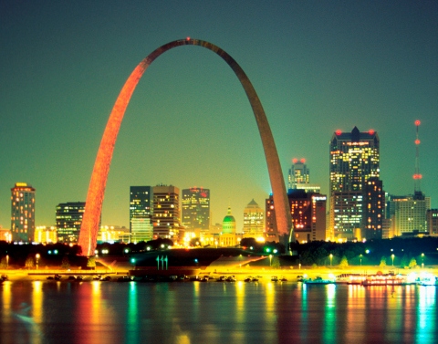 A nighttime view of St Louis and the Arch from across the waters of the Mississippi River