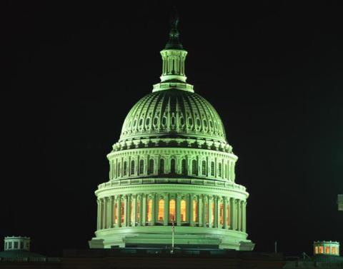 The dome of the US Senate building at night in a greenish light