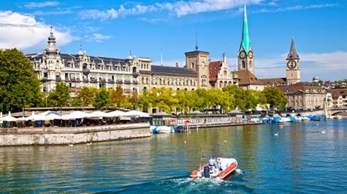 Zurich Switzerland Cityscape On Canal With Speedboat