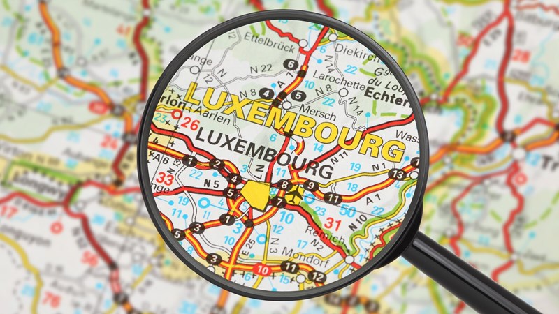Magnifying glass zooming in on Luxembourg