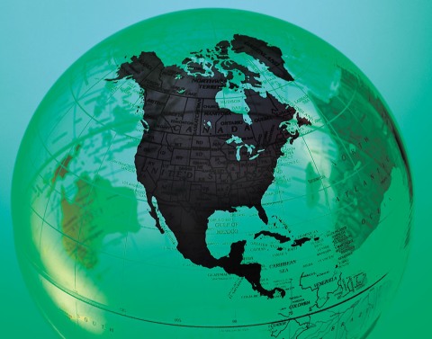 A globe with North America featured prominently in black and the other continents shown in green