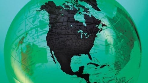 A globe with North America featured prominently in black and the other continents shown in green