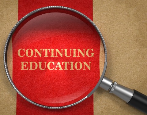 Tan parchment paper with a wide red stripe containing the words CONTINUING EDUCATION with a magnifying glass on top