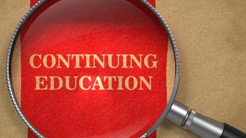 Tan parchment paper with a wide red stripe containing the words CONTINUING EDUCATION with a magnifying glass on top